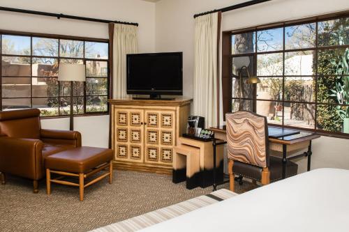 a hotel room with a bed and a television at La Posada De Santa Fe, a Tribute Portfolio Resort & Spa in Santa Fe