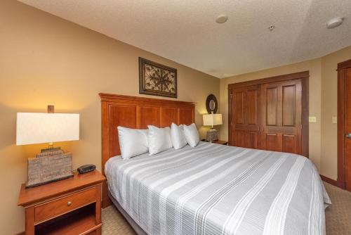 a bedroom with a bed and a table with a lamp at A207 One Bedroom Lake View in Oakland