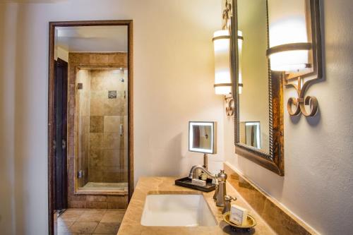 a bathroom with a sink and a mirror at La Posada De Santa Fe, a Tribute Portfolio Resort & Spa in Santa Fe