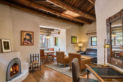 a living room with a couch and a fireplace at La Posada De Santa Fe, a Tribute Portfolio Resort & Spa in Santa Fe