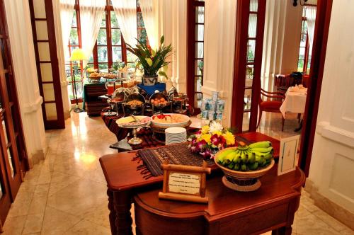 a dining room with a table with food on it at Settha Palace Hotel in Vientiane