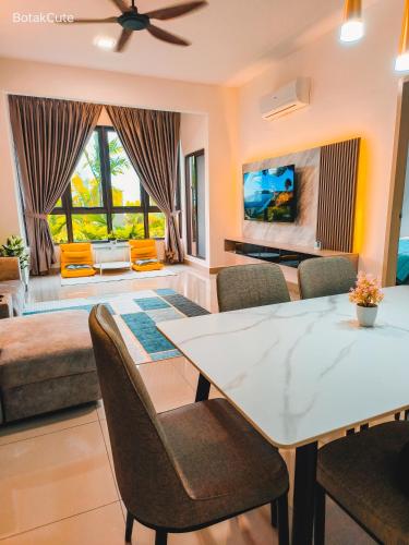 a living room with a table and chairs and a couch at BotakCuteHomestay@BaliResidence in Melaka