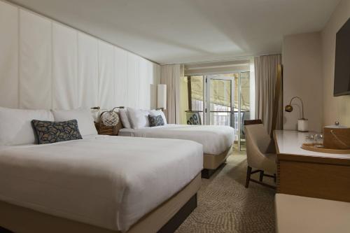 a hotel room with two beds and a desk at Newport Marriott Hotel & Spa in Newport