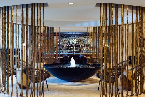a lobby with a fountain in a room with chairs at Newport Marriott Hotel & Spa in Newport