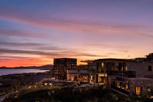 a view of a building at sunset with the ocean at Zadún, a Ritz-Carlton Reserve, Los Cabos in San José del Cabo