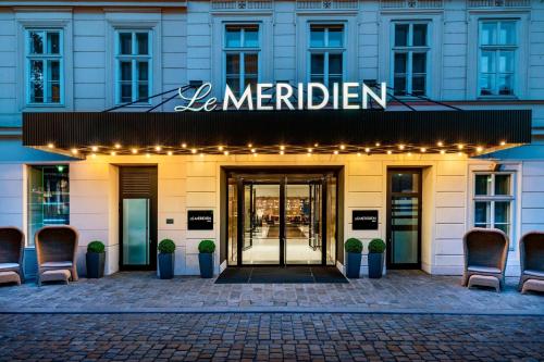 a hotel entrance with a sign that reads be meridian at Le Méridien Vienna in Vienna