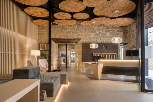 a lobby with wooden logs on the ceiling at Palacio Tondón, La Rioja Brinas, Autograph Collection in Briñas