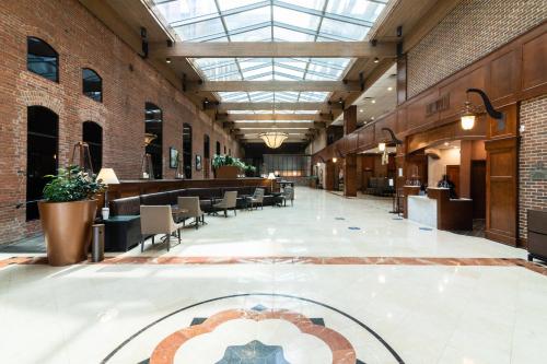 an empty lobby with tables and chairs in a building at Columbus Marriott in Columbus