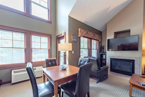 a dining room with a table and chairs and a fireplace at A308 Studio & Loft Standard View in Oakland