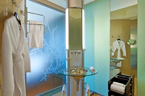 a bathroom with a glass table and a shower at Le Méridien Beach Plaza in Monte Carlo