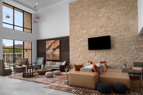 a living room with a couch and a stone wall at Element Moab in Moab