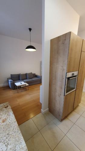 a living room with a couch and a refrigerator at Apartamenty Sedinum in Szczecin