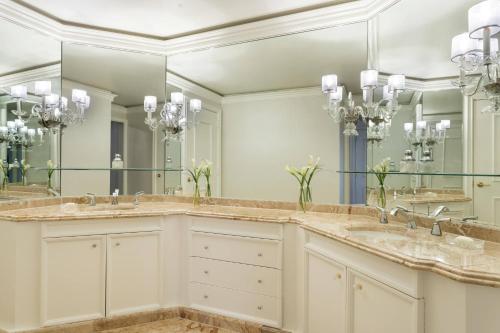 a bathroom with two sinks and two mirrors at The Ritz-Carlton, Marina del Rey in Los Angeles