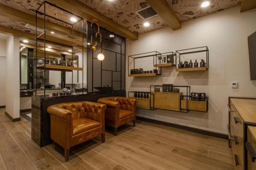 a bar with brown leather chairs in a room at JW Marriott Las Vegas Resort & Spa in Las Vegas