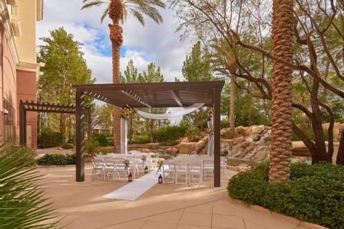 a set up for a wedding with white tables and chairs at JW Marriott Las Vegas Resort & Spa in Las Vegas