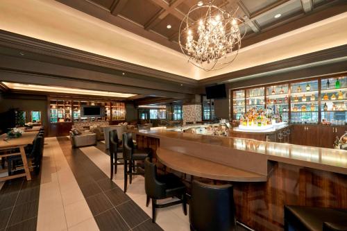 a restaurant with a bar with tables and chairs at JW Marriott Las Vegas Resort & Spa in Las Vegas