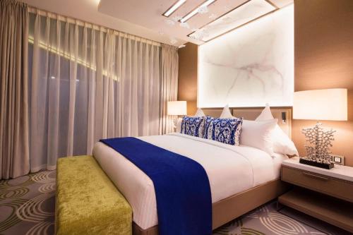 a hotel room with a large bed and a window at Paragraph Resort & Spa Shekvetili, Autograph Collection in Shekvetili
