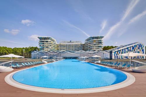 a large swimming pool in front of a building at Paragraph Resort & Spa Shekvetili, Autograph Collection in Shekvetili
