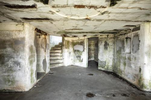 an empty room with stairs in an old building at Captain's Quarters in Seaside