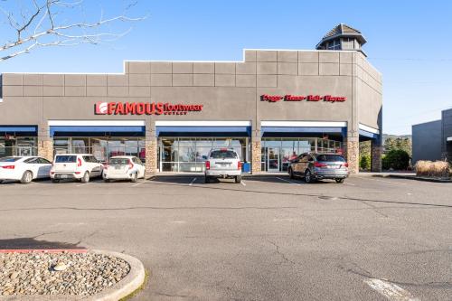 a car dealership with cars parked in a parking lot at Captain's Quarters in Seaside