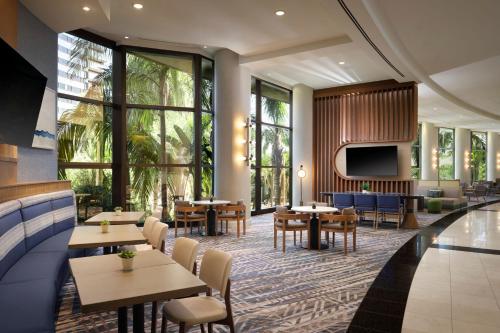 a restaurant with tables and chairs and a tv at San Diego Marriott Marquis and Marina in San Diego