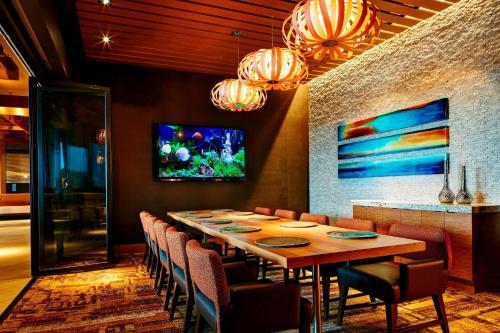 a dining room with a long table and chairs at Marriott Marquis San Diego Marina in San Diego