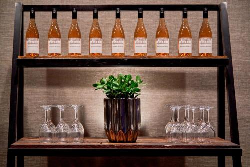 a shelf with wine glasses and a vase with a plant at Renaissance Nashville Hotel in Nashville