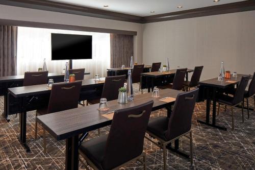 a conference room with tables and chairs and a flat screen tv at Renaissance Nashville Hotel in Nashville