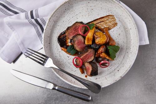 a bowl of food with meat and vegetables on a table at Renaissance Nashville Hotel in Nashville