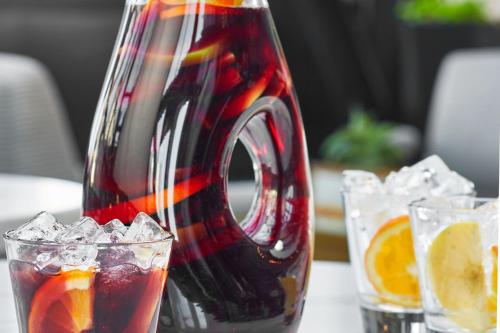 a drink pitcher sitting on a table next to two glasses at Renaissance Nashville Hotel in Nashville