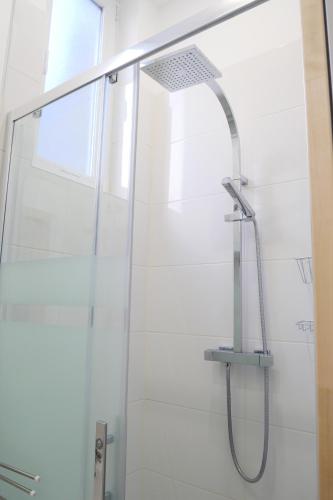 a shower with a shower head in a bathroom at "Pieds dans l'eau", Dunkerque plage, digue de mer Malo les bains, T2 in Dunkerque