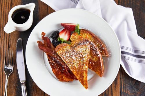 a plate of french toast with bacon and fruit at Renaissance Nashville Hotel in Nashville