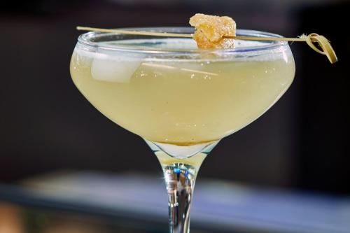a martini glass with a yellow drink with a stick in it at Renaissance Nashville Hotel in Nashville