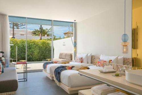 a bedroom with two beds and a large window at W Ibiza in Santa Eularia des Riu