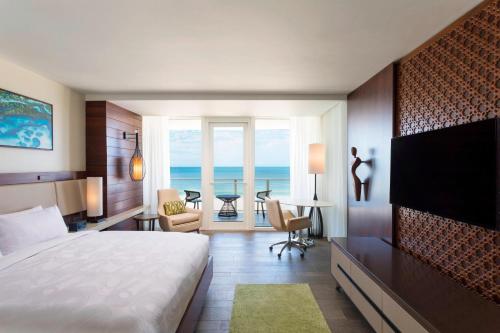 a hotel room with a bed and a view of the ocean at JW Marriott Marco Island Beach Resort in Marco Island