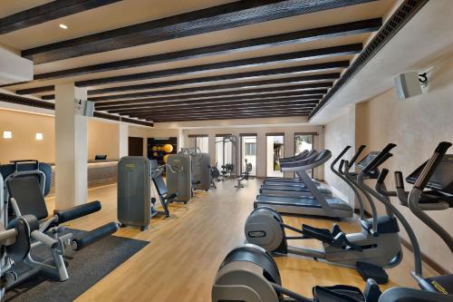 a gym with treadmills and elliptical machines at Al Wathba, a Luxury Collection Desert Resort & Spa, Abu Dhabi in Abu Dhabi