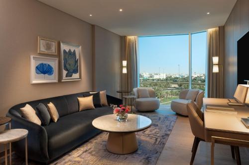 a living room with a couch and a table at The St. Regis Kuwait in Kuwait