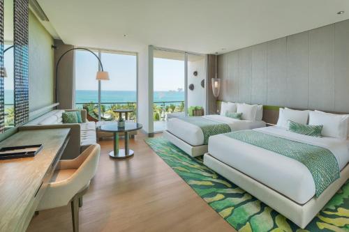 a hotel room with two beds and a balcony at W Bali - Seminyak in Seminyak