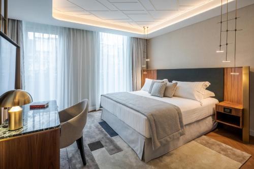 a hotel room with a bed and a desk at Casa Baglioni Milan - The Leading Hotels of the World in Milan