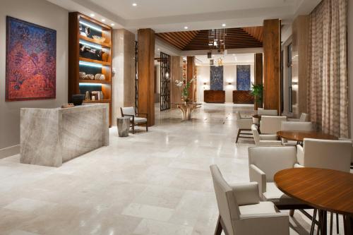 een lobby van een hotel met tafels en stoelen bij The Santa Maria, a Luxury Collection Hotel & Golf Resort, Panama City in Panama-Stad