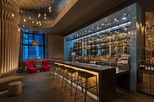 a bar in a room with a bunch of bottles of alcohol at W Philadelphia in Philadelphia