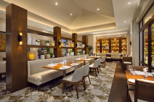 a restaurant with tables and chairs in a room at The Santa Maria, a Luxury Collection Hotel & Golf Resort, Panama City in Panama City