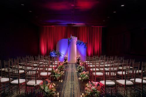 a row of chairs in a room with red curtains at W Philadelphia in Philadelphia