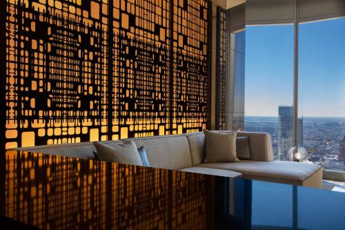 a living room with a couch and a glass table at W Philadelphia in Philadelphia