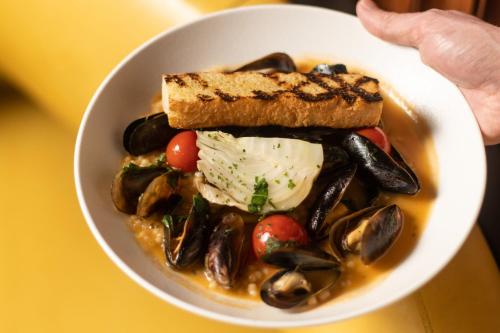 a bowl of food with mussels and a sandwich at W Philadelphia in Philadelphia