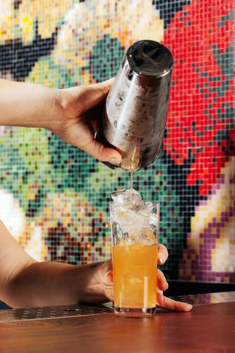 a person is pouring a drink into a glass at W Philadelphia in Philadelphia
