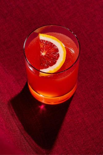 a glass of red drink with a slice of grapefruit at W Philadelphia in Philadelphia