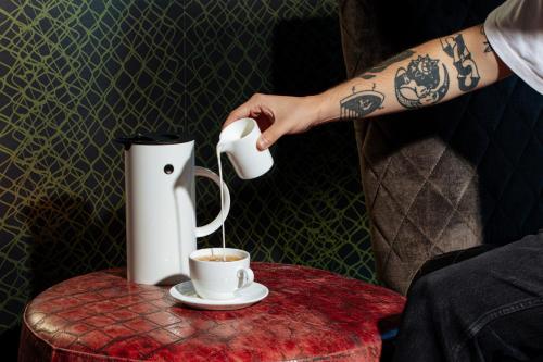 a person pouring coffee into a cup on a table at W Philadelphia in Philadelphia