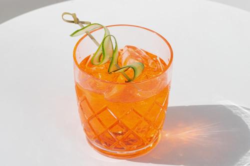 a glass of orange juice with a green plant in it at W Philadelphia in Philadelphia