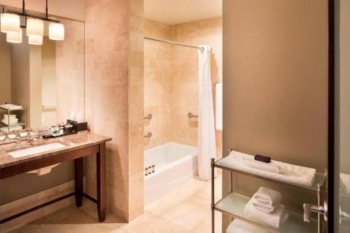 a bathroom with a tub and a sink and a shower at Hotel Ivy, a Luxury Collection Hotel, Minneapolis in Minneapolis